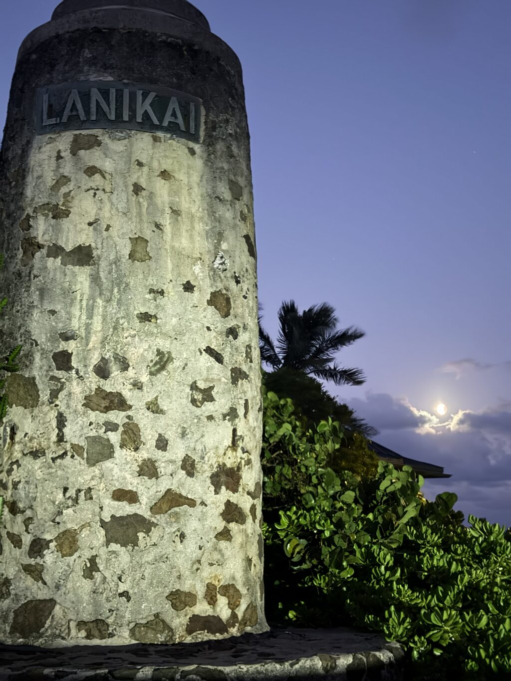 Lunar eclipse over the historic Lanikai Monument in Lanikai, Oahu, photographed on August 27, 2026, with the moon visible above the coastal neighborhood.