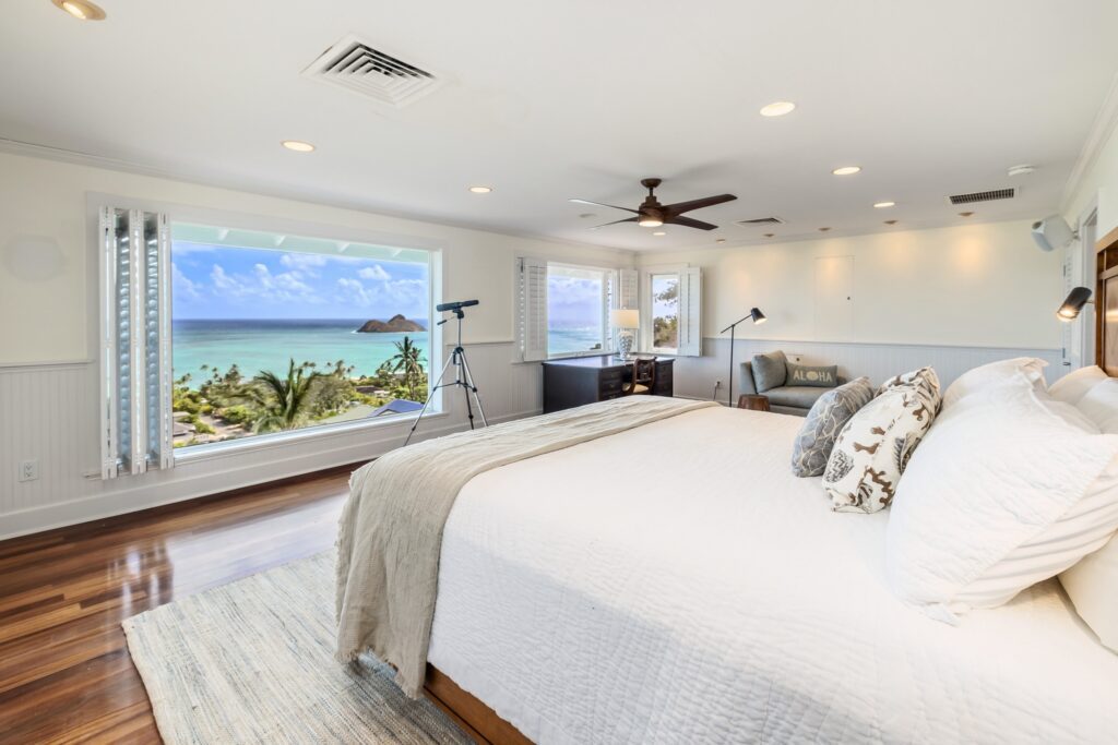 Primary suite king bed with Mokulua Islands view at Koohoo Place