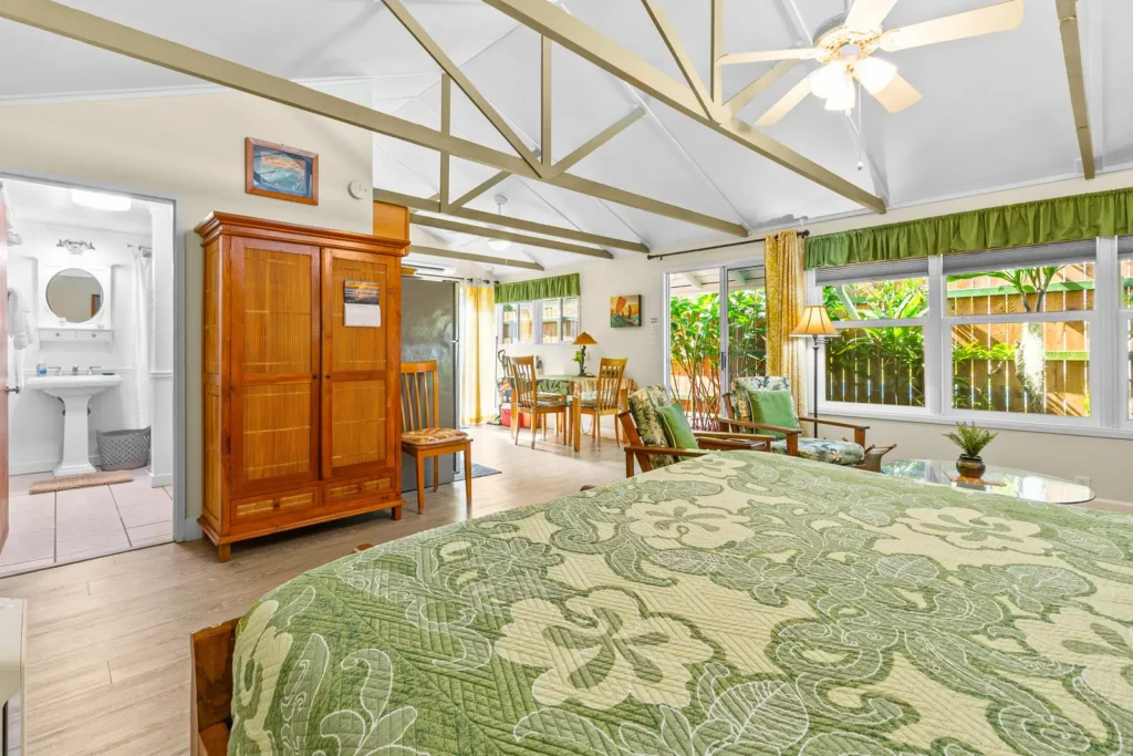 King bed with tropical bedspread at Lanikai Garden Studio