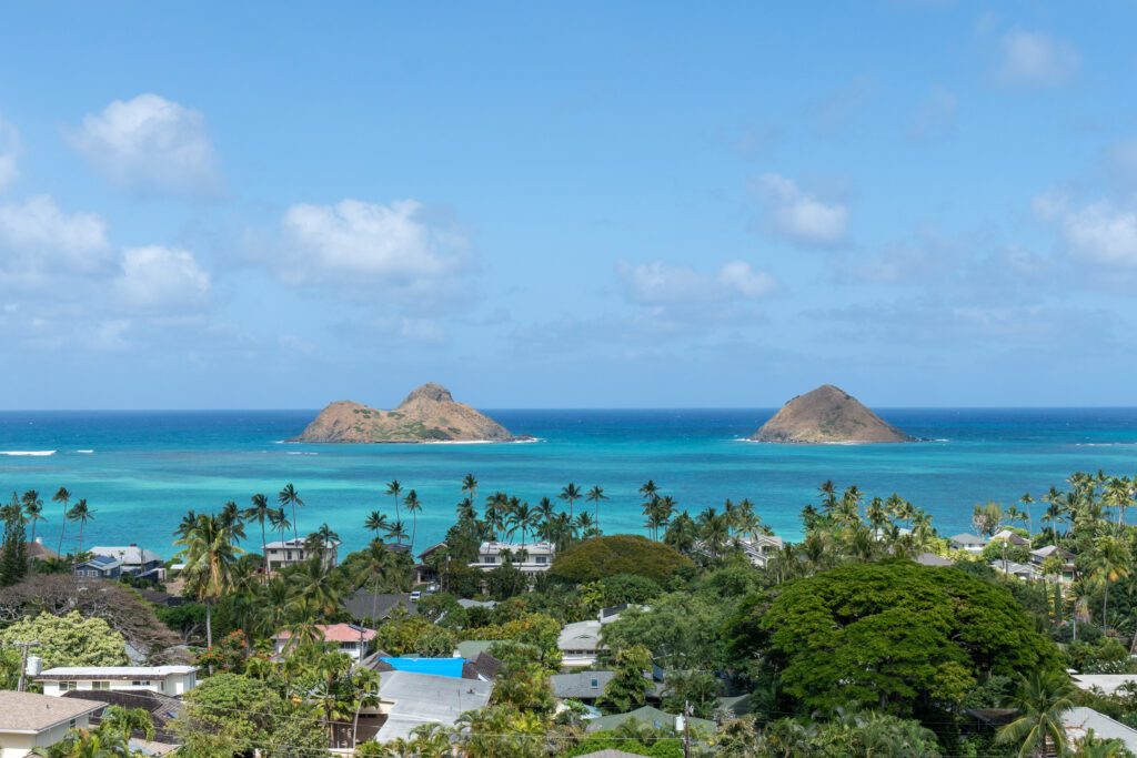 View over Lanikai rooftops to the Mokulua Islands and turquoise water at Makani Moana