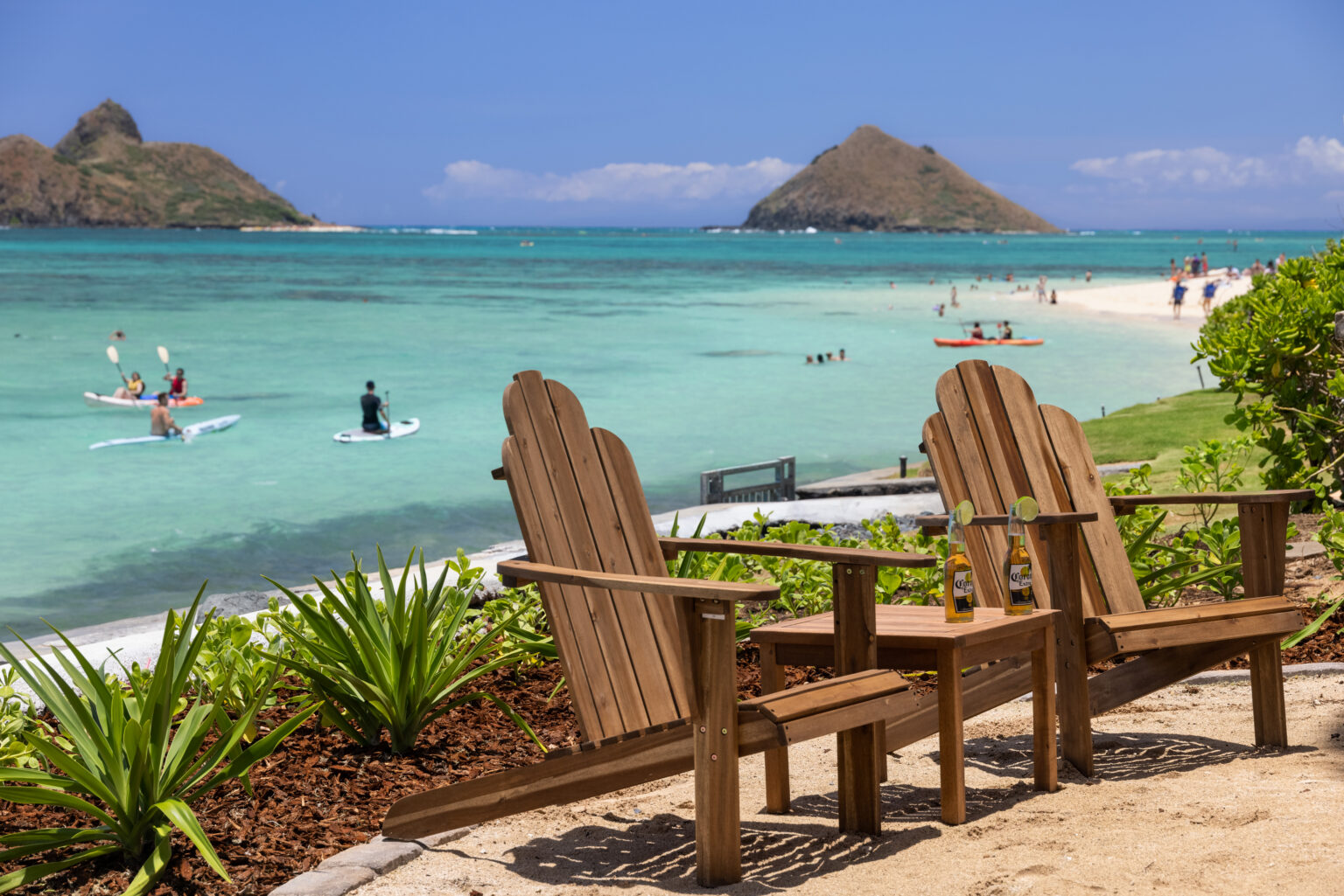 Adirondack chairs on the oceanfront lawn facing the Mokulua Islands at Moku Nui