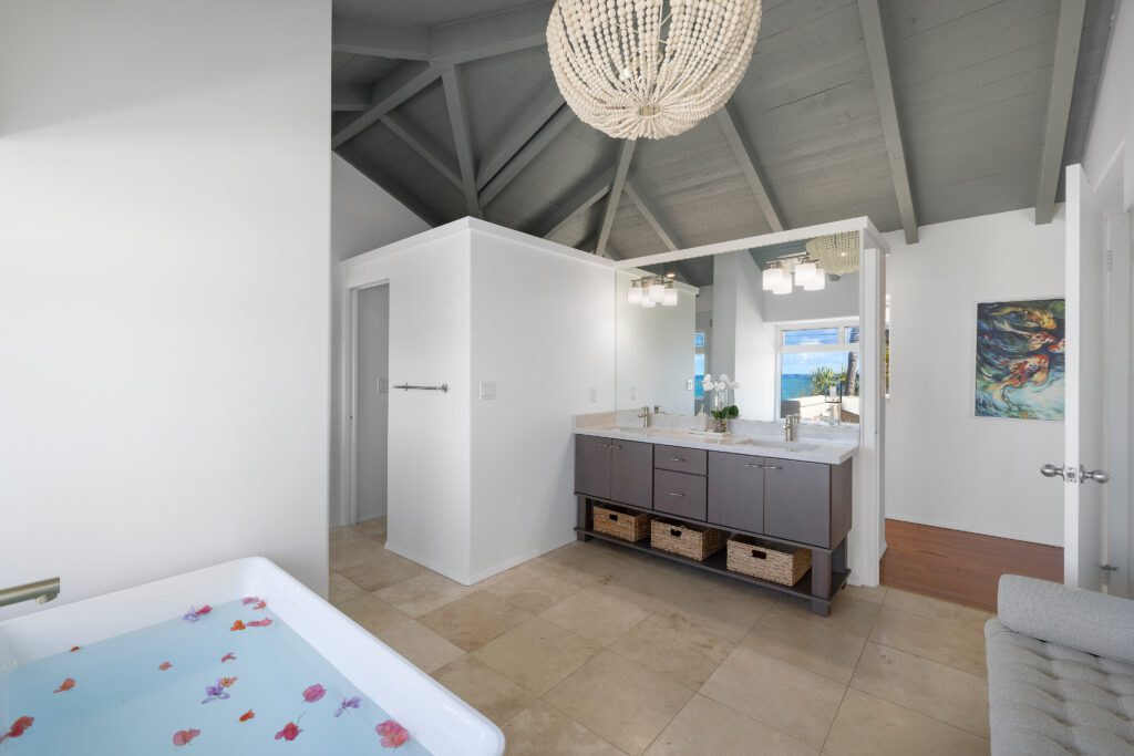 Primary bathroom with soaking tub and double vanity at Moku Nui