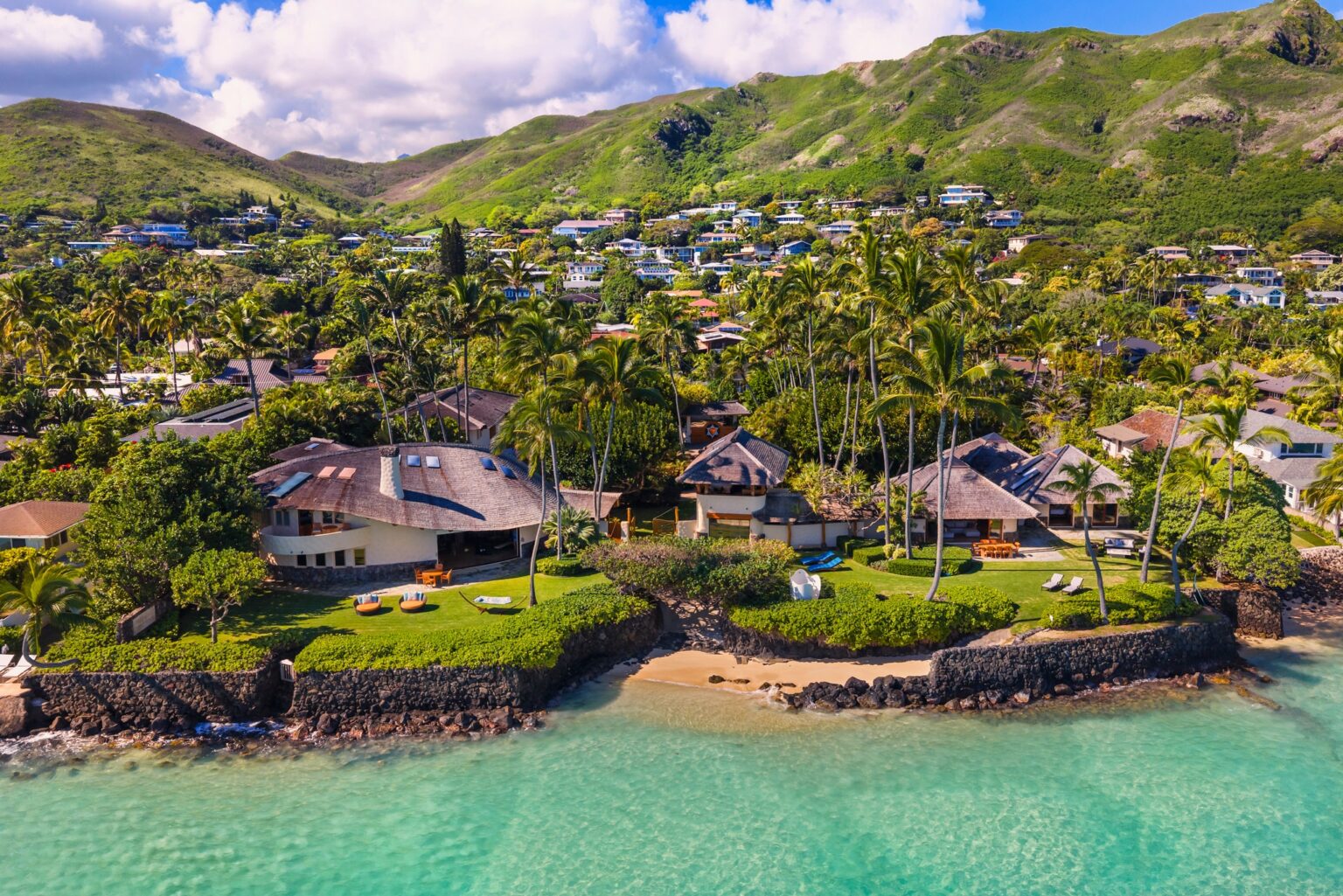 Aerial view of the beachfront estate and Lanikai shoreline beneath the Koʻolau Mountains at Paul Mitchell Estate