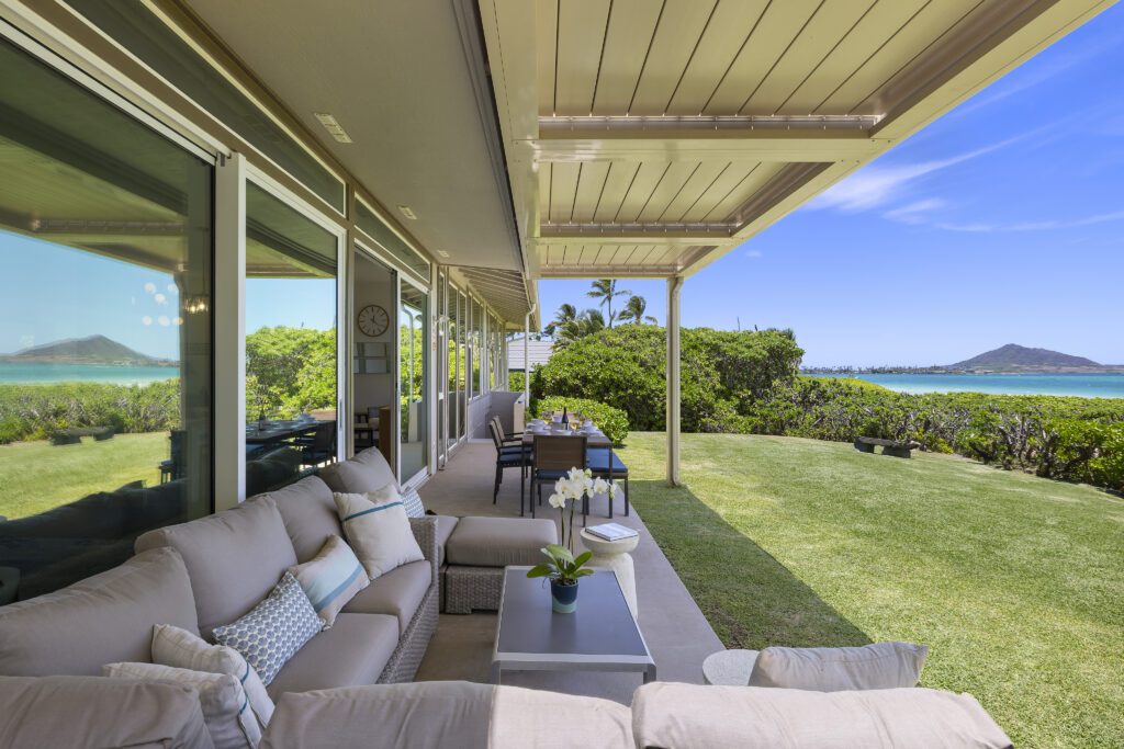 Covered oceanfront lanai with sectional seating and a view of the Mokulua Islands at Pueohala