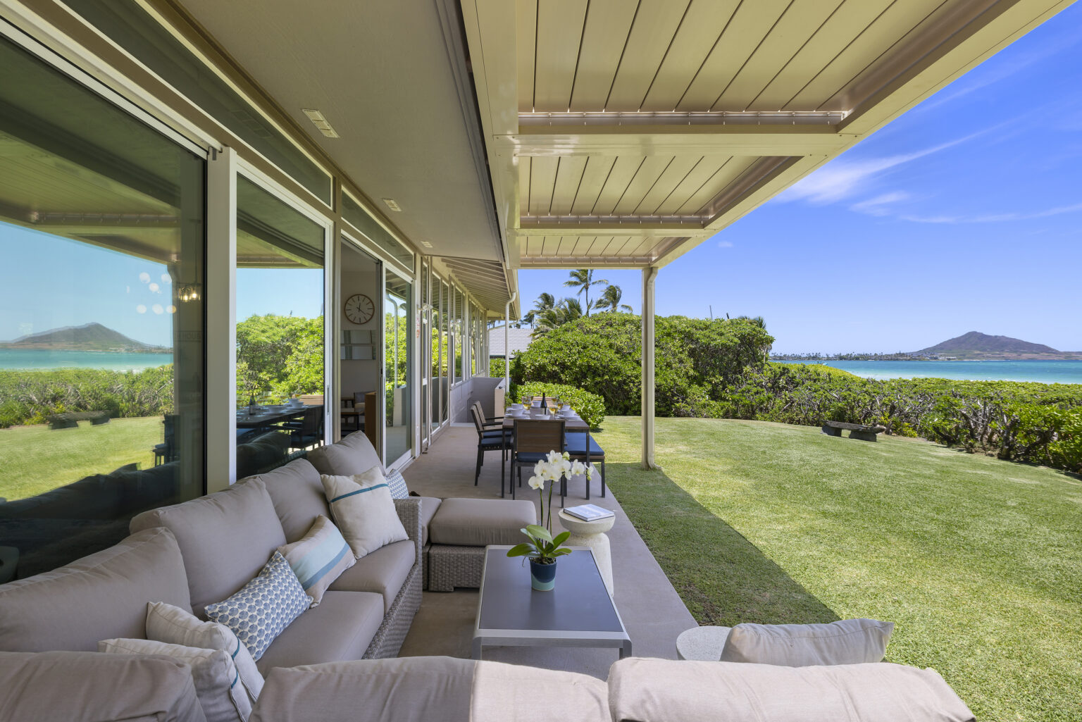 Covered oceanfront lanai with sectional seating and a view of the Mokulua Islands at Pueohala